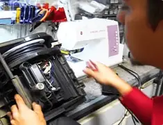 Vacuum repair technician servicing internal components on a workbench in Boulder, CO