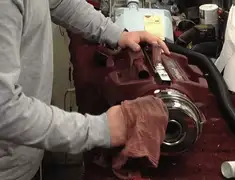 Vacuum repair technician cleaning and servicing a vacuum motor in Boulder, CO